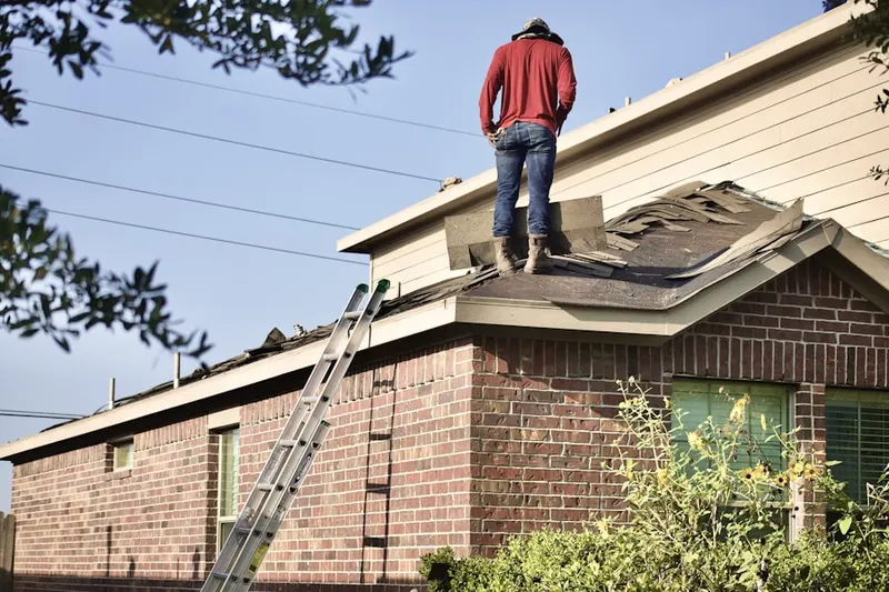 Professional roofer working on a residential roof in Cave Springs